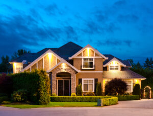 a two-story home for sale in Banner Elk, NC. the lights are on and the lawn is well manicured 