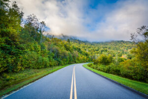 The Blue Ridge Parkway cuts through beautiful mountains in the afternoon sun.