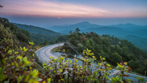 the Blue Ridge Parkway winding through the mountains as the sun begins to set